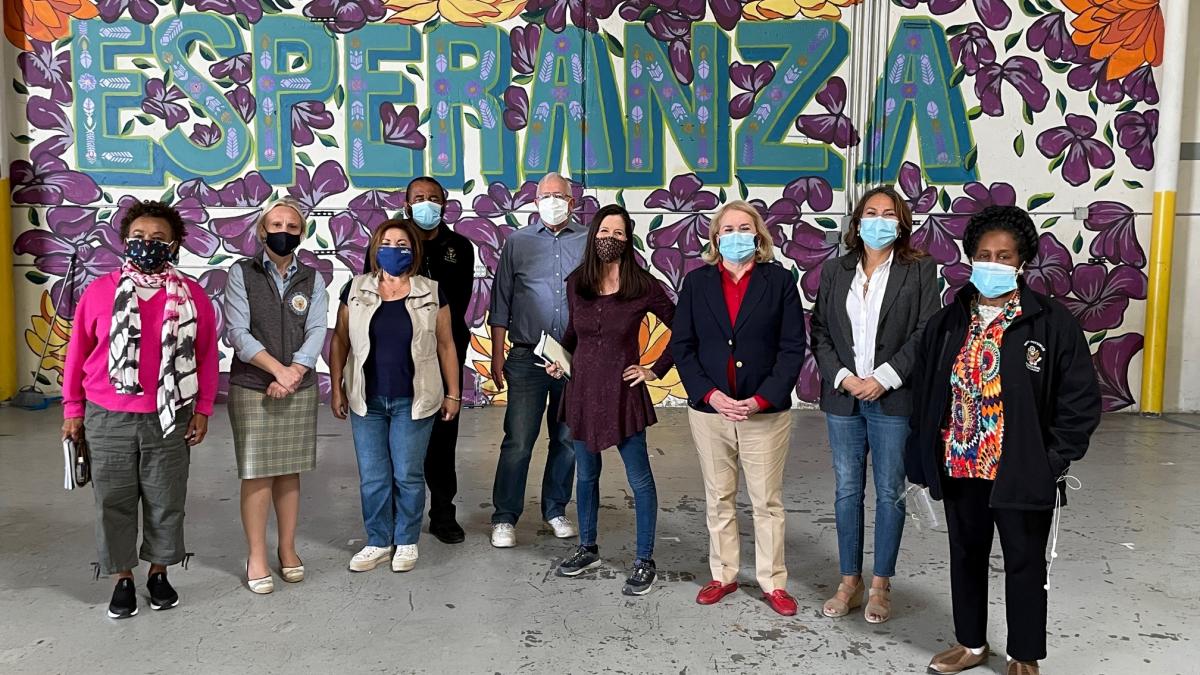 Members of Congress in front of a wall that says Esperanza